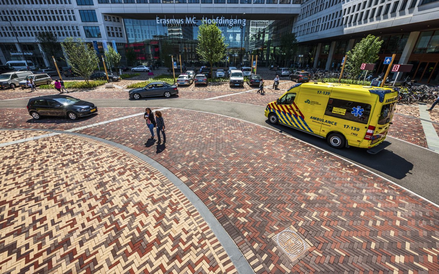 Aerial shot showing pavers used for this case study in front of building, with cars and people in shot