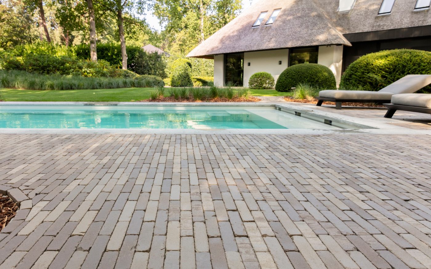 Close up shot of pavers used for this case study, with pool and building in background