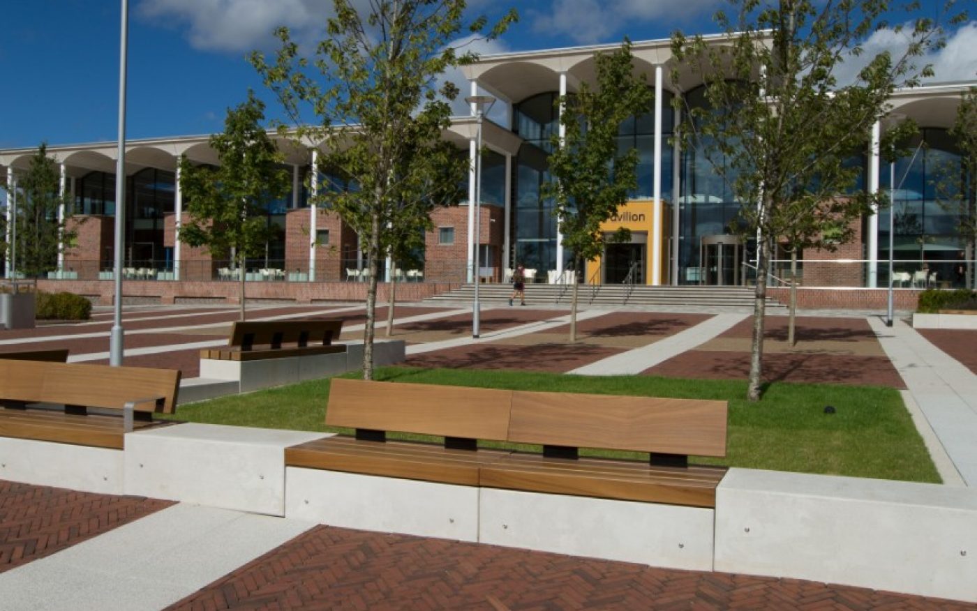 Bench outside paved path leading to building
