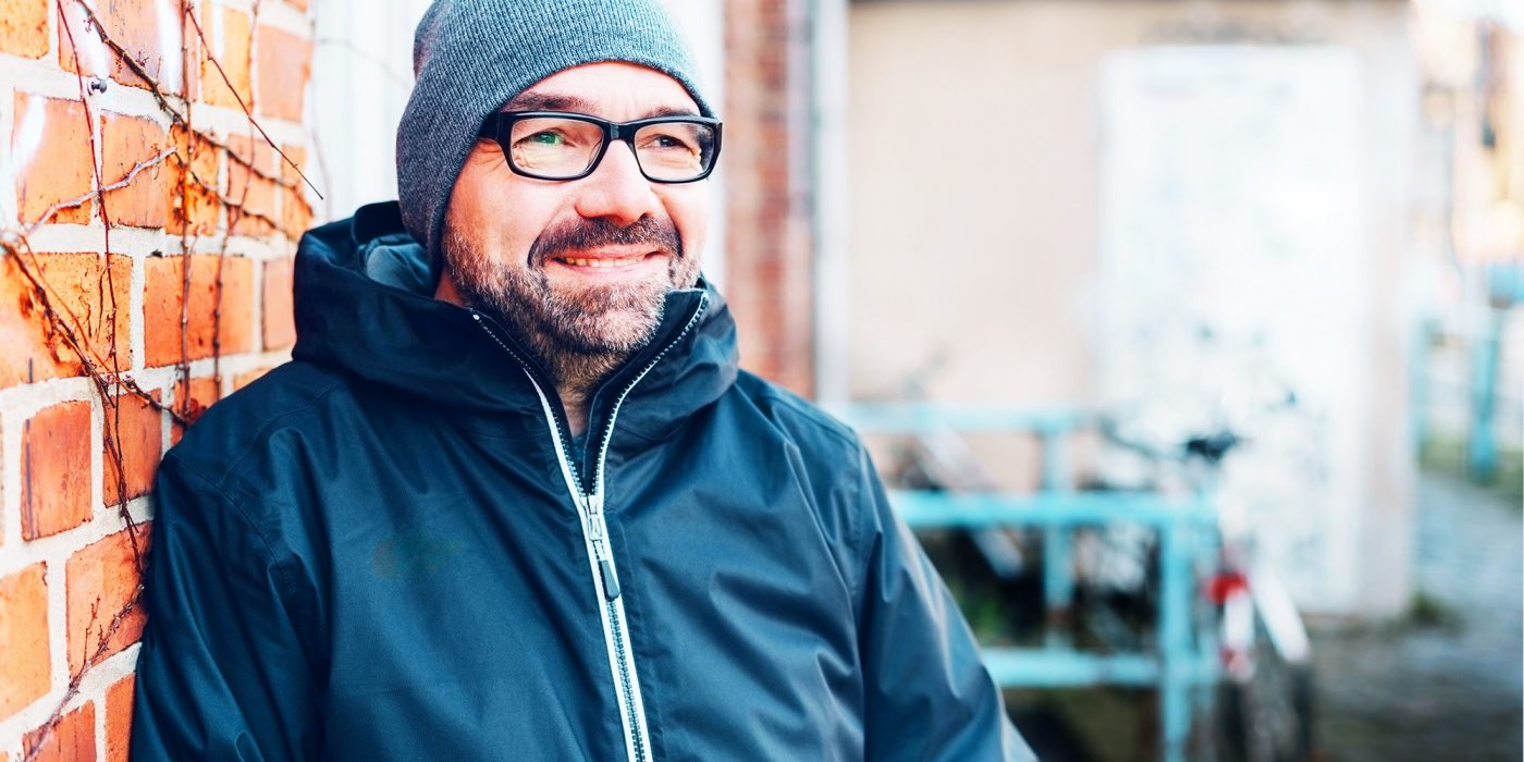 Thoughtful man smiling as he stares ahead