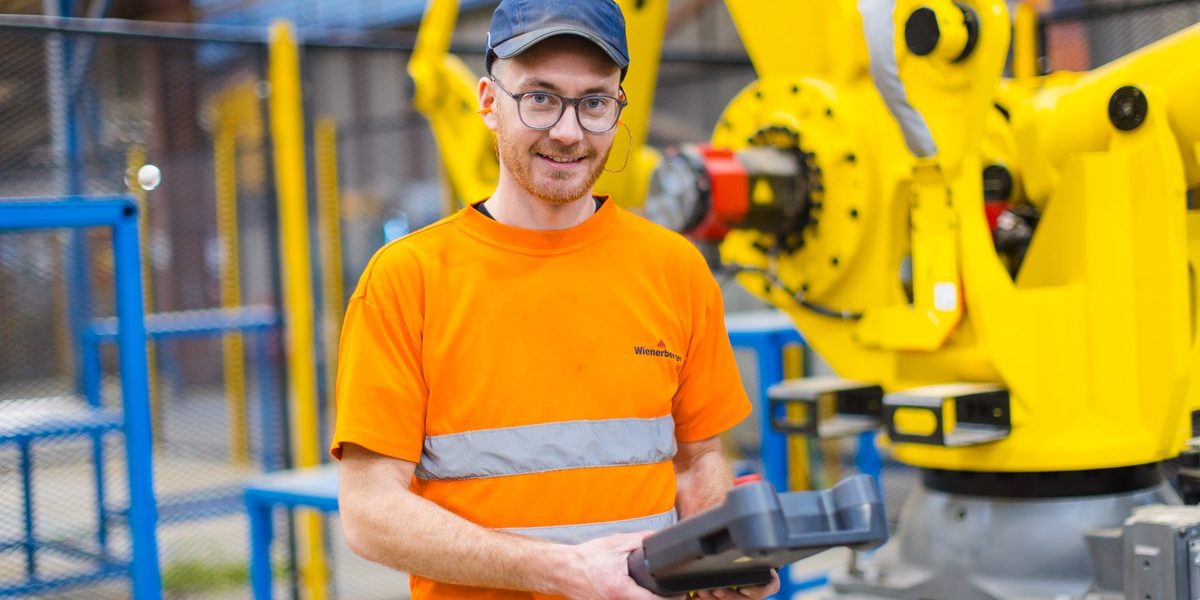 Man working at the Ewhurst Factory smiling towards the camera