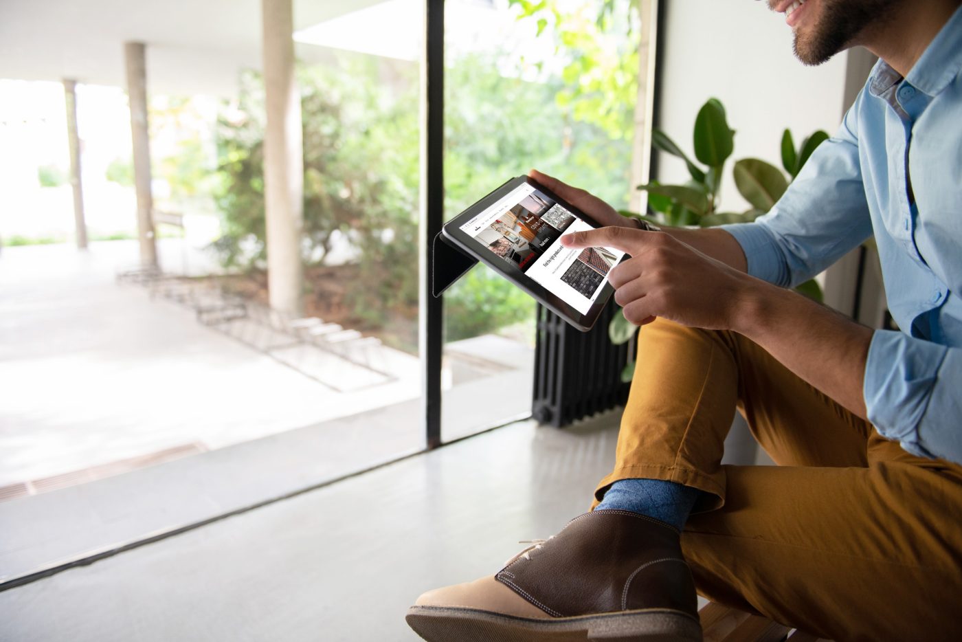 Picture shows a man using an iPad displaying Wienerberger UK website.