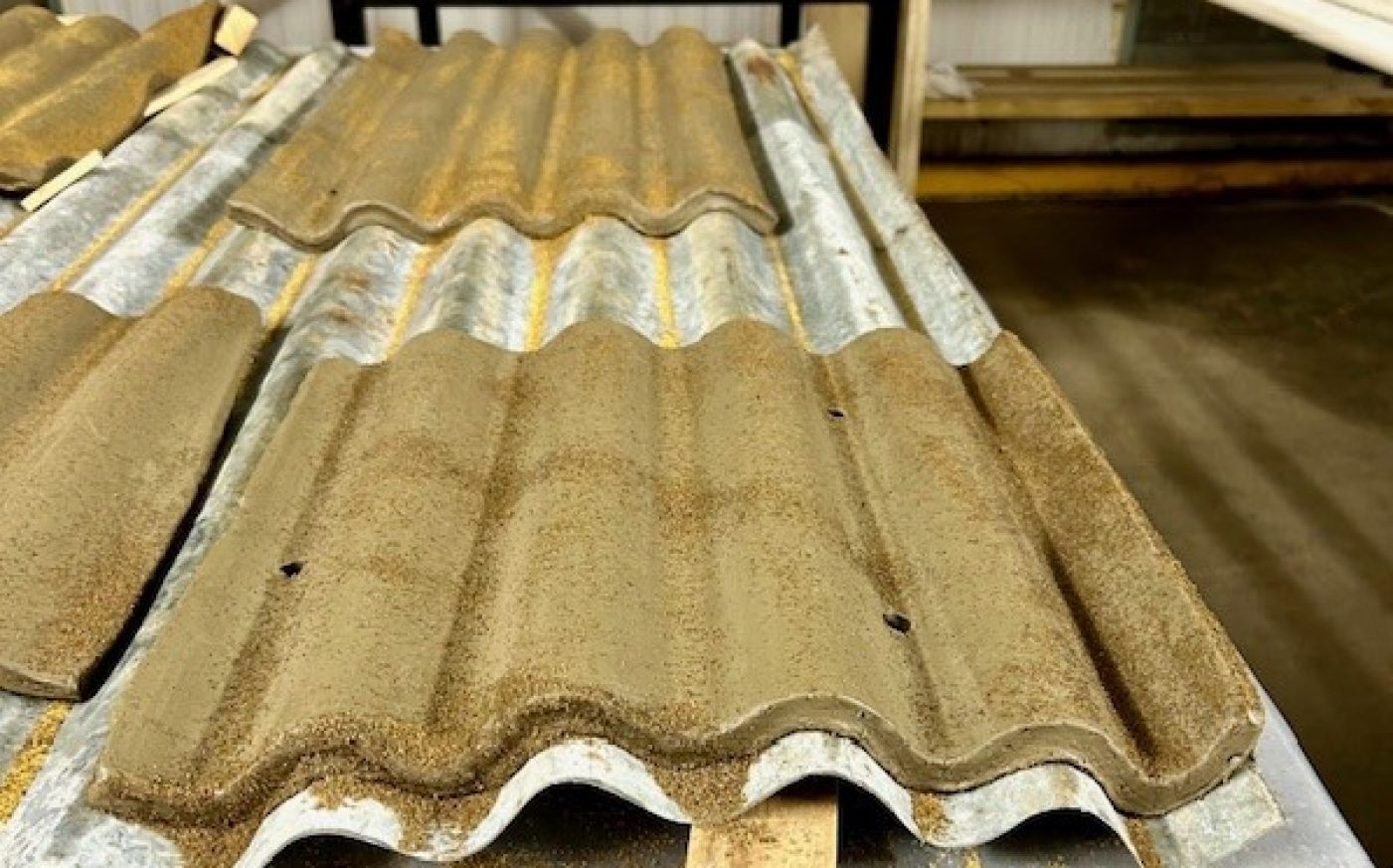 Image of clay being moulded into ridged panels