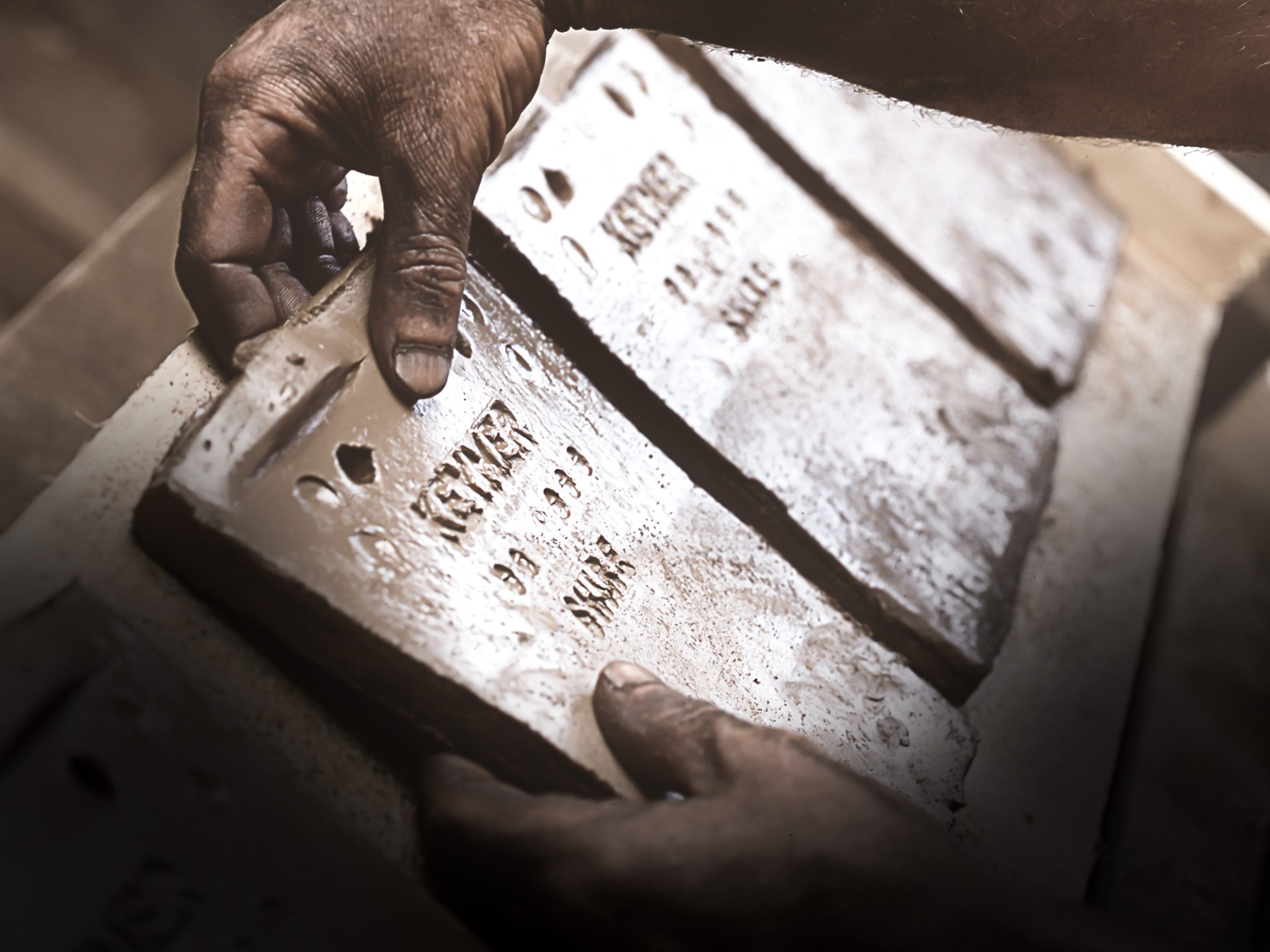 Man placing handmade clay tile to dry