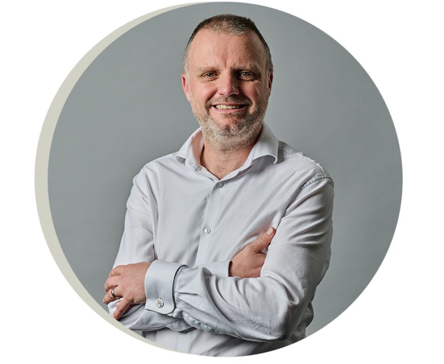 Simon Nevitt headshot against a grey brackground