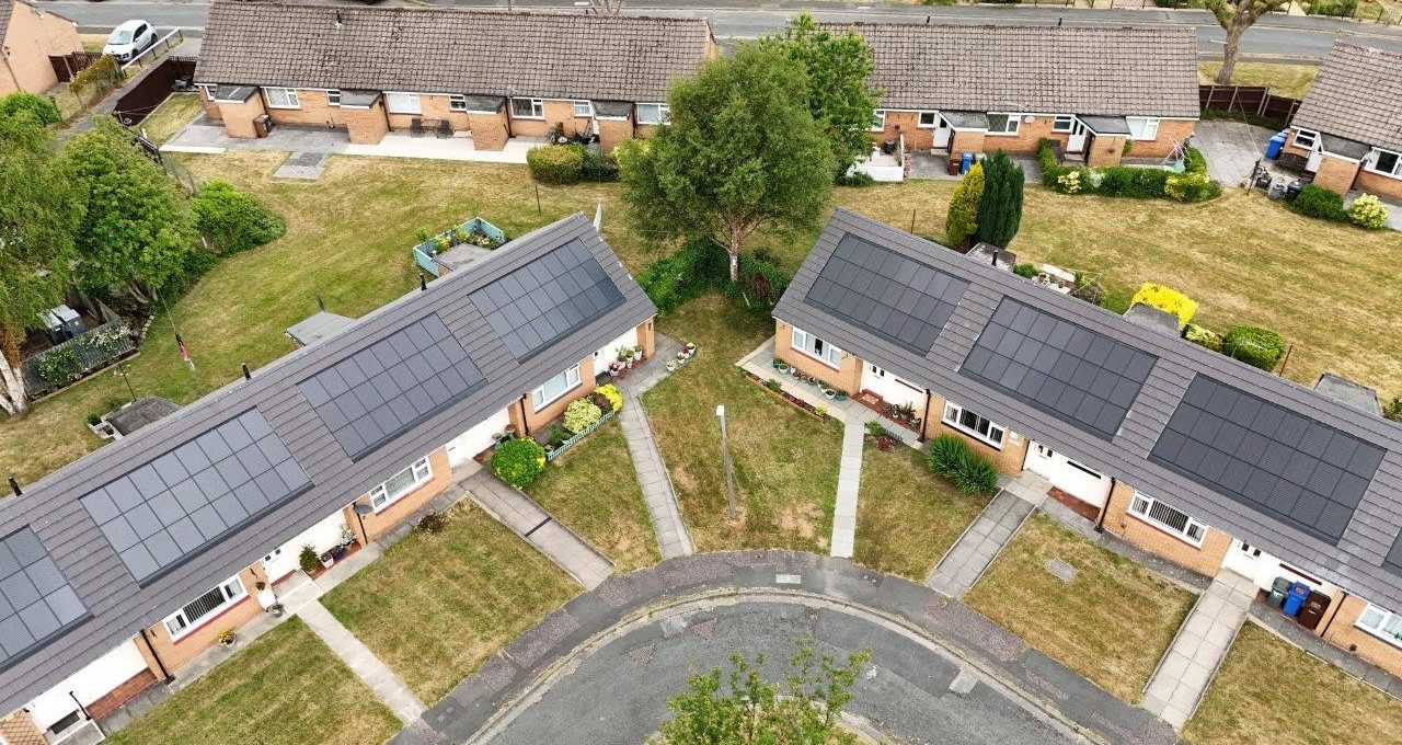 Bird’s-eye view of a row of houses on a corner with paths leading to each entrance