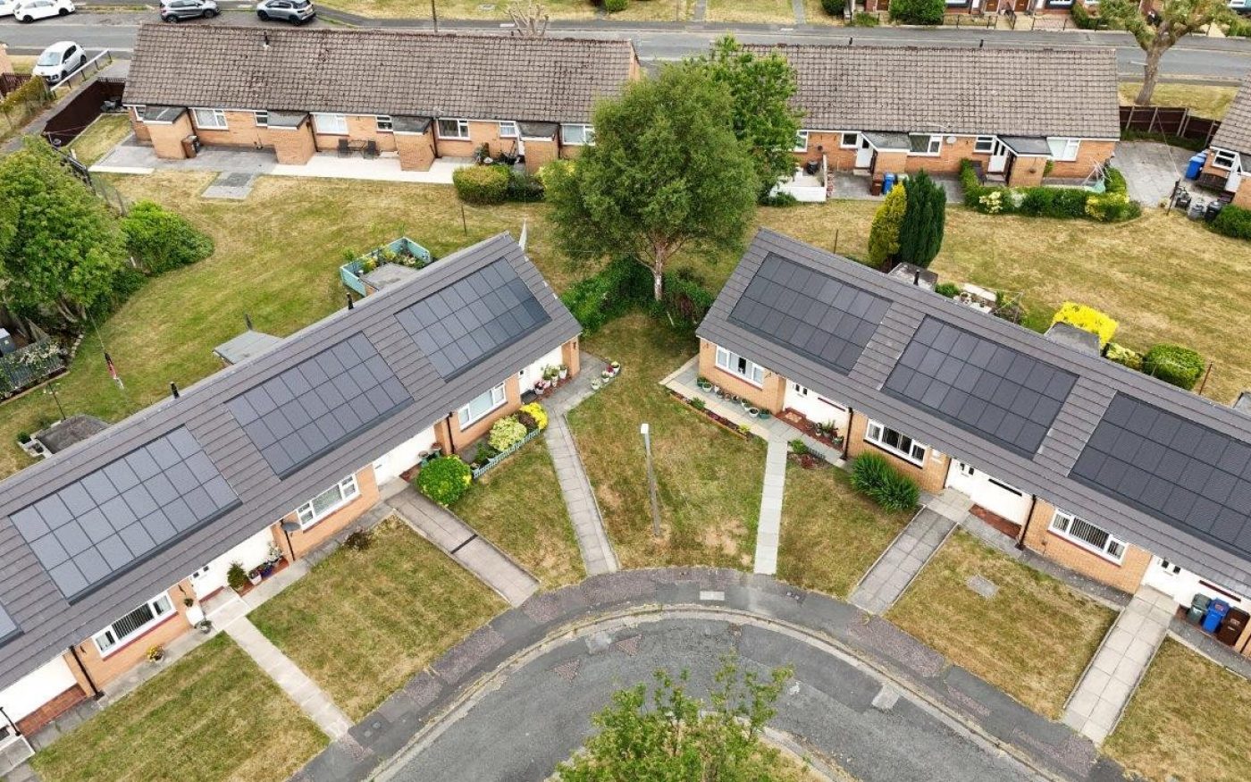 Overhead view of a row of houses with a road connected by footpaths