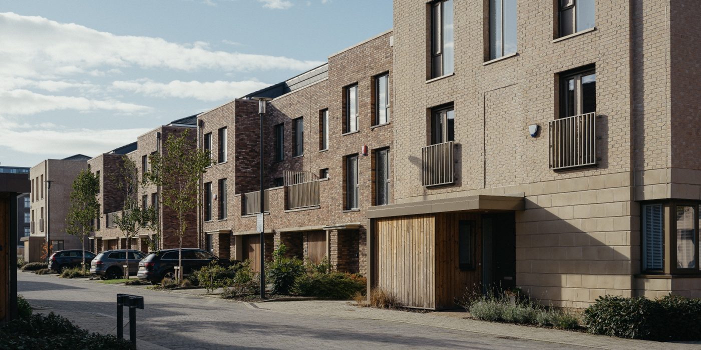Row of brown modern terraced houses featuring balconies