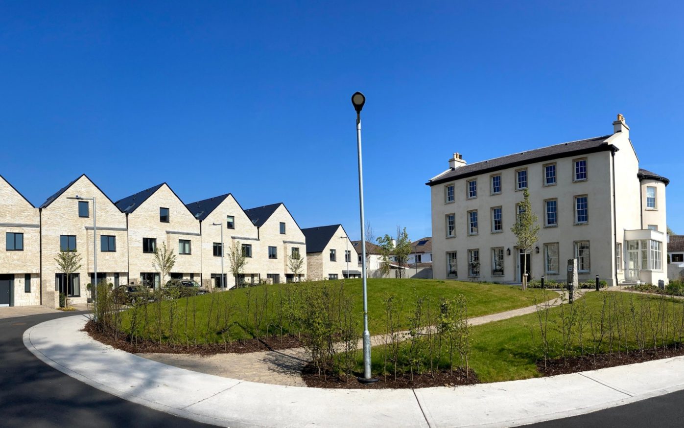 Historic Prospect House with landscaped front garden, next to row of modern terraced houses