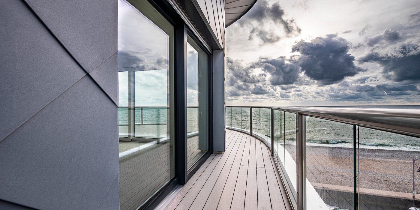 Seaton Beach passivhaus exterior with sea view from balcony