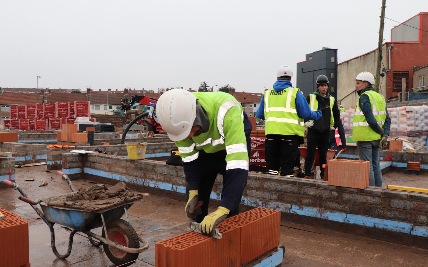 Men on site laying Porotherm blay blocks