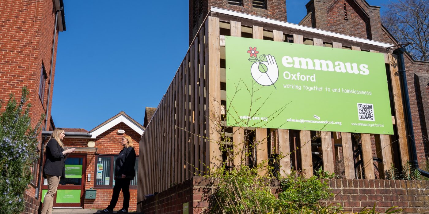Large Emmaus sign in green on the side of a building