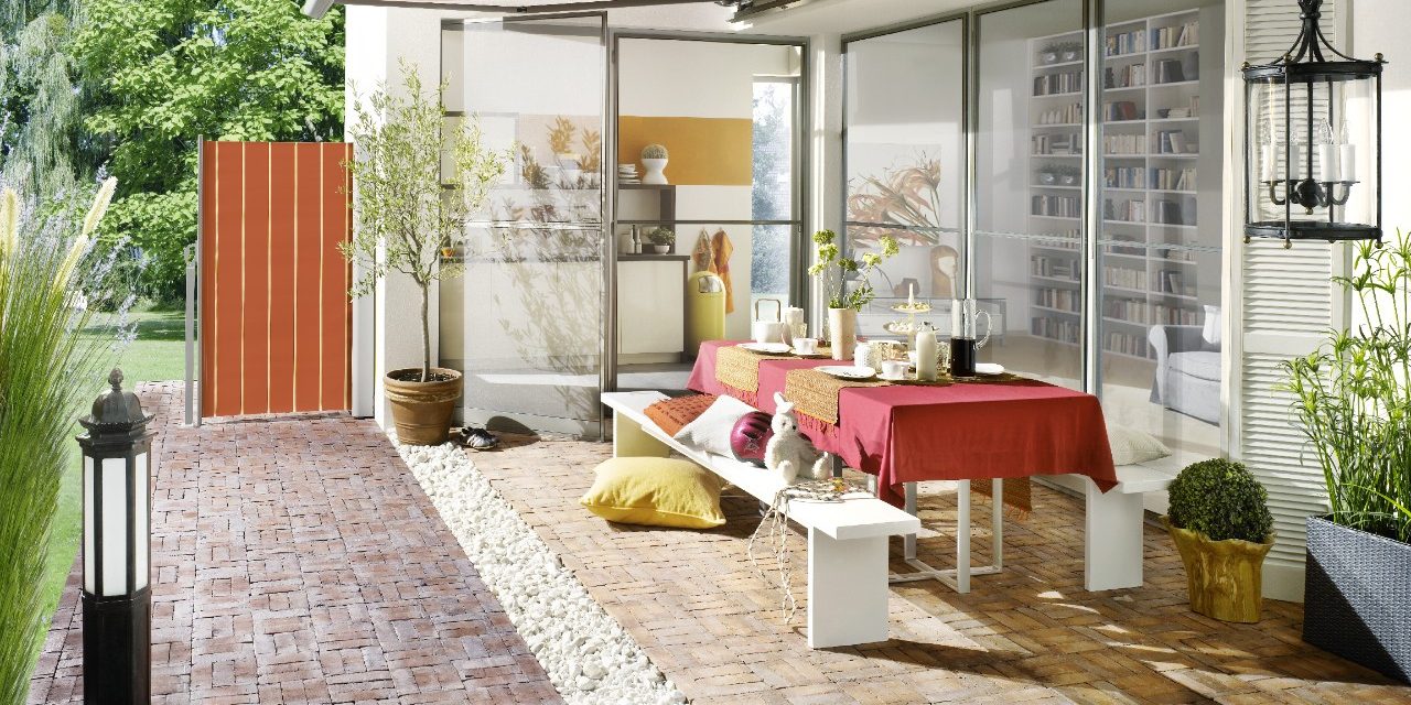Modern outside dining area with table and benches