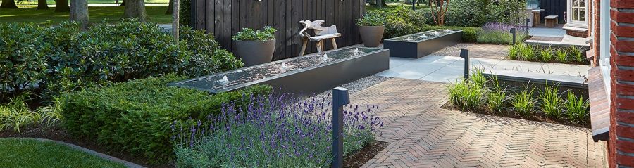 Modern garden with clay paving and water features