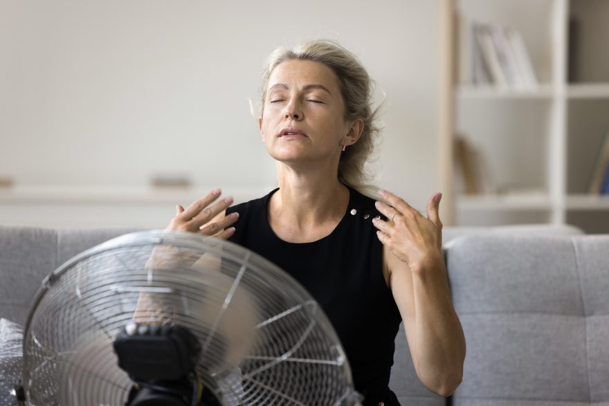 Women sat infront of a fan keeping cool