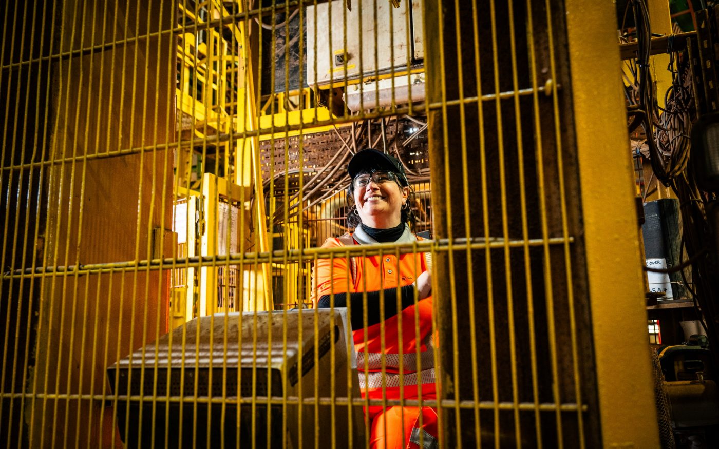 Image of a woman in construction controlling machinery