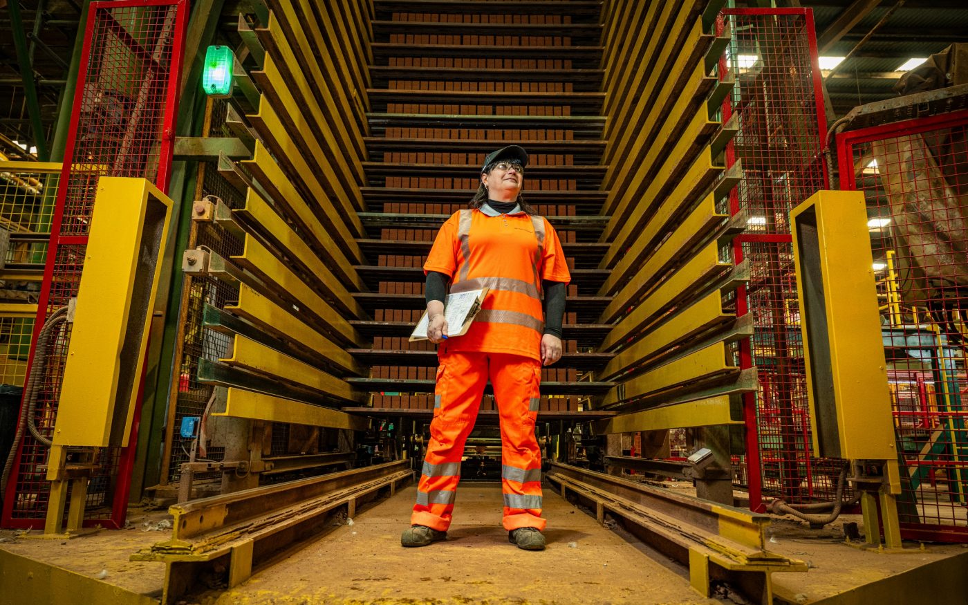 Image of a woman in construction standing in a factory