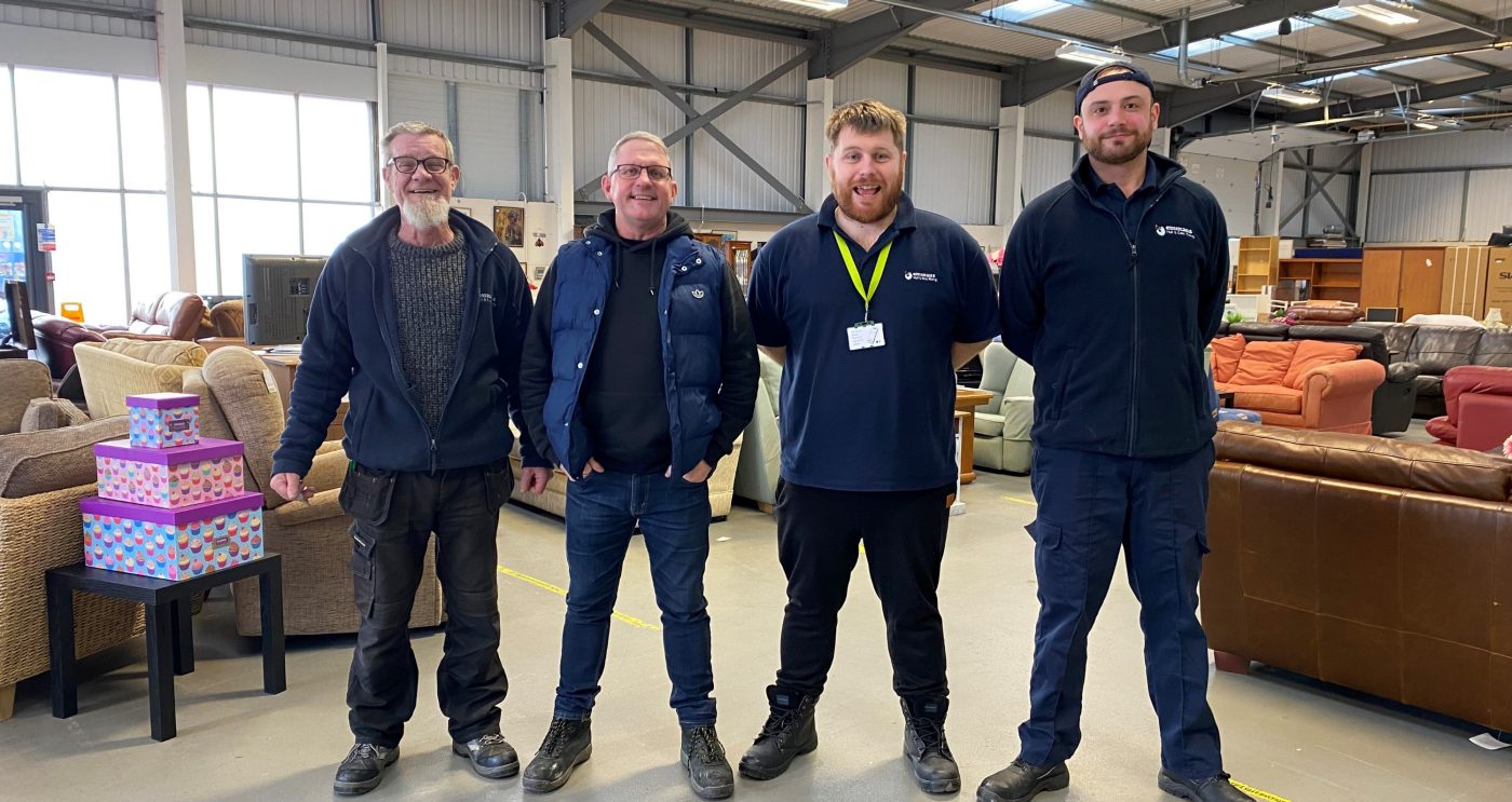 Group image of 4 men smiling whilst volunteering