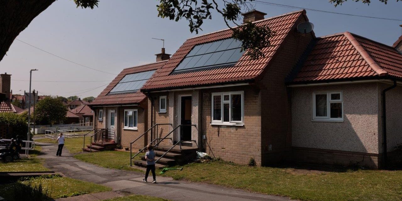 Terraced bungalows with newly installed solar panels on roof