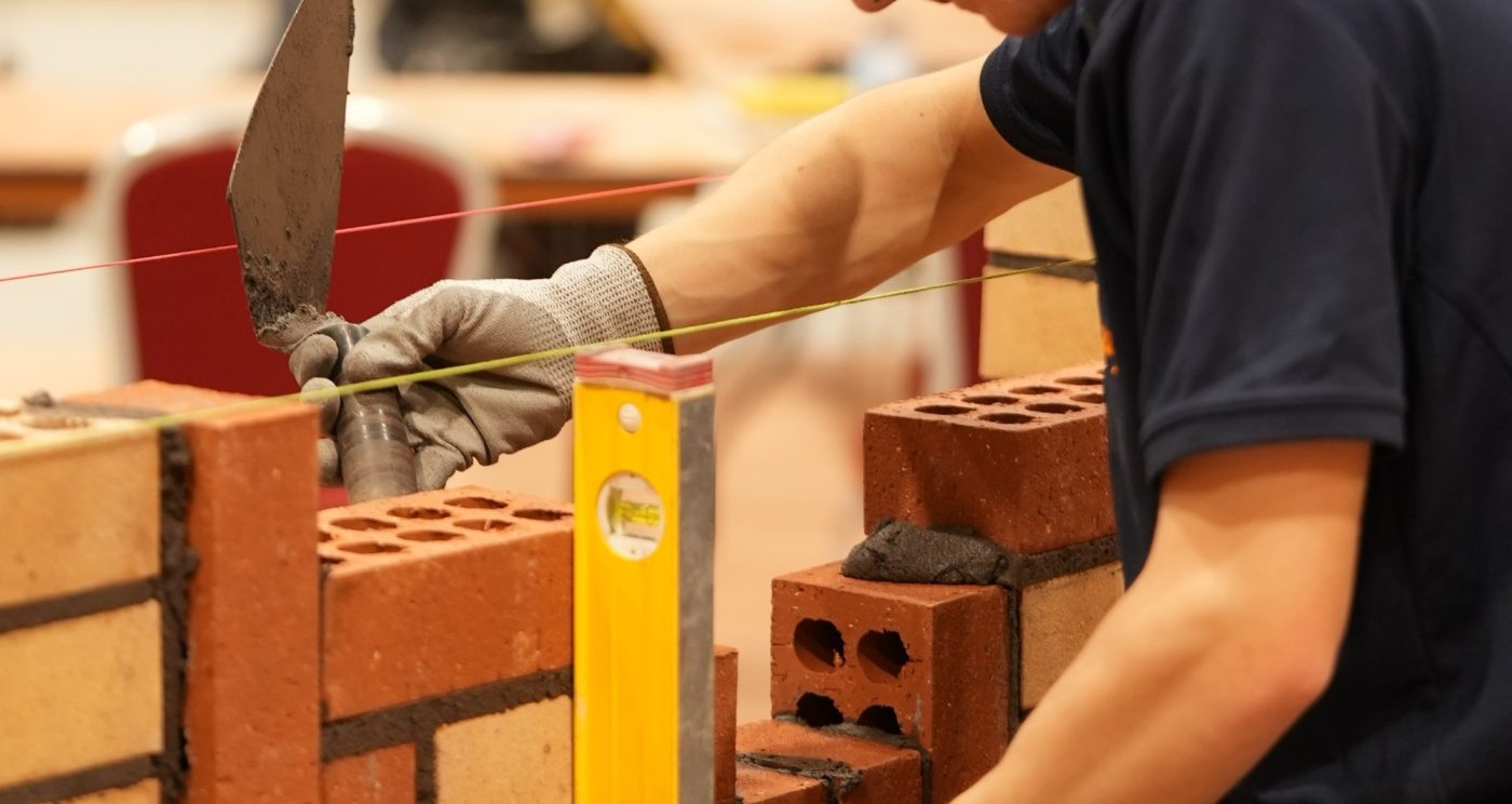 Person bulding a wall in the SkillBuild competition