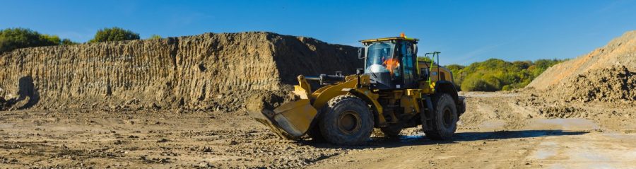 Tractor in the middle of a Quarry with blue sky