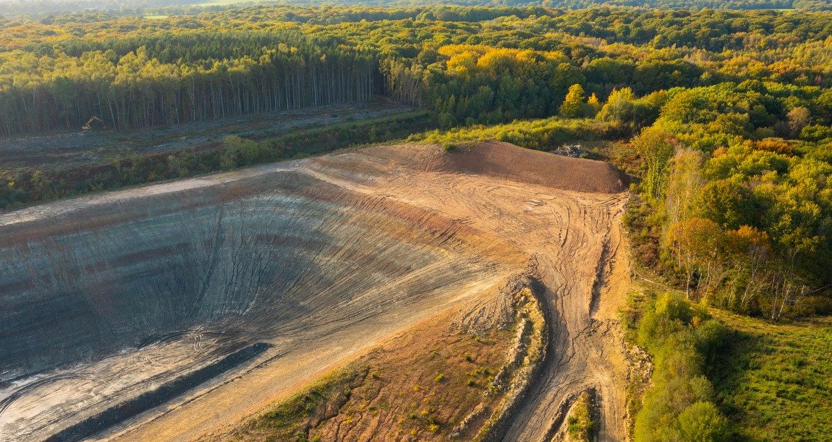 Historical photo of a man unloading clay from a wheelbarrow to make bricks