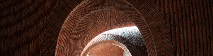 Man standing in brick archway