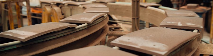 Clay roof tiles on production line