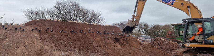 Digger at a factory site helping form new habitat for swift birds