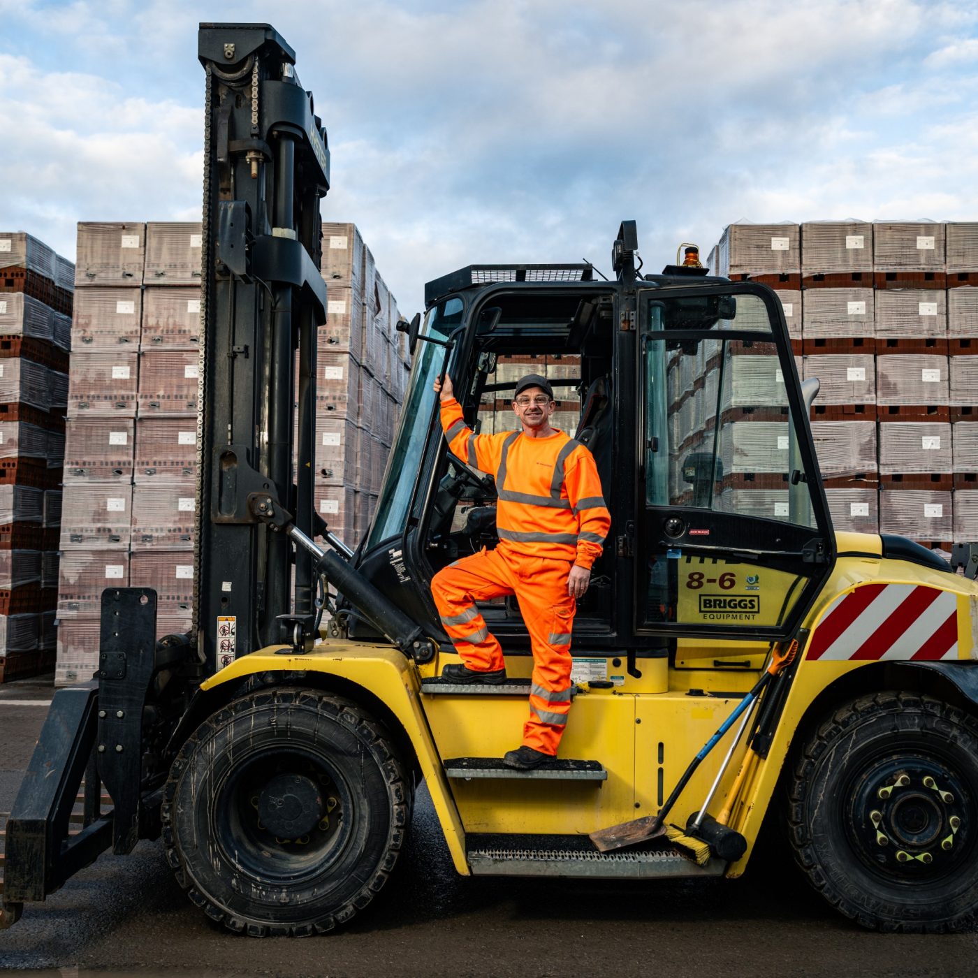 Employee stood on forklift step