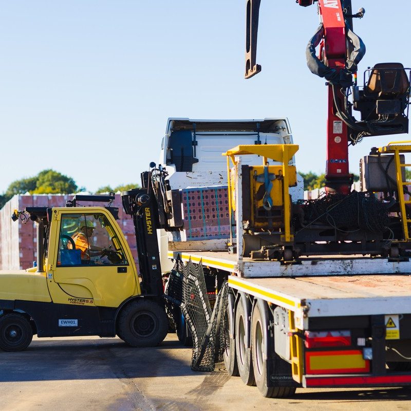 forklift loading a lorry with pallets