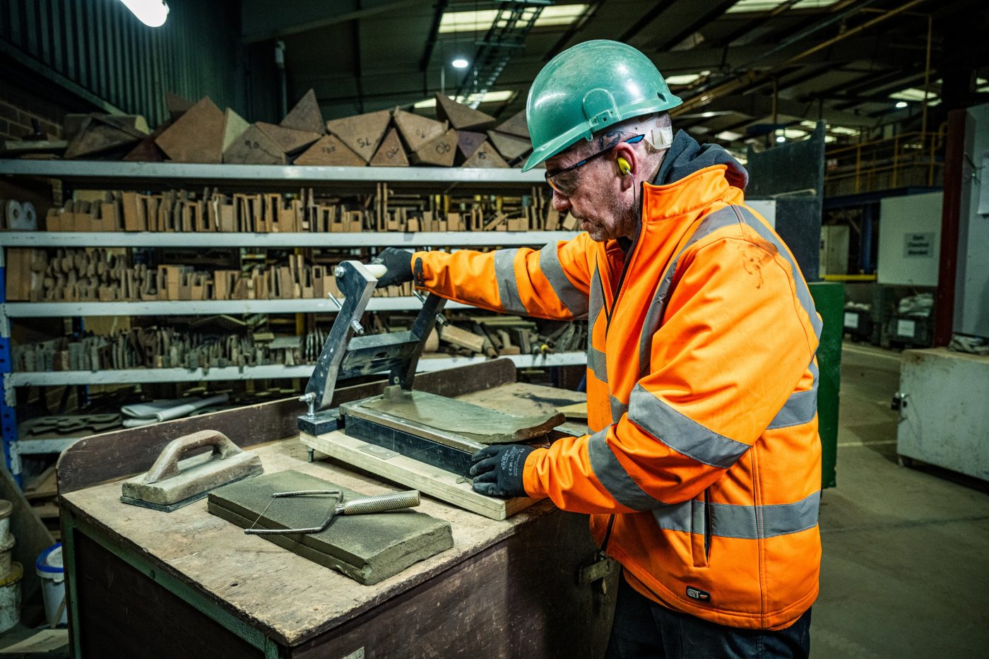 Employee hand making a roof tile