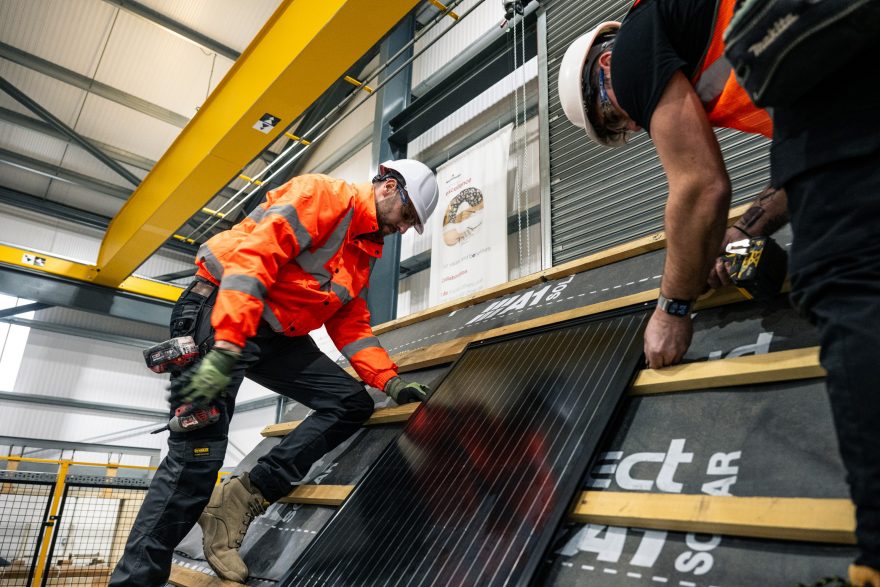 two employees demonstrating in-roof solar installation in Sandtoft factory