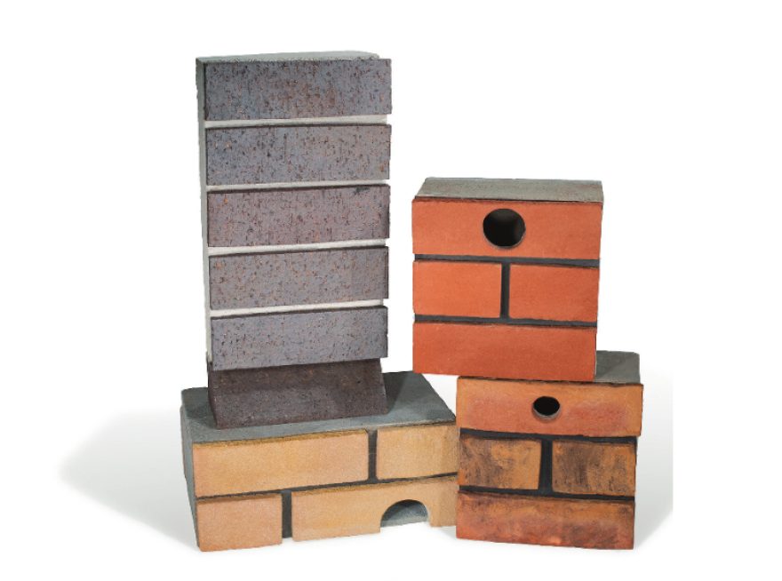 Different styles of bird and bat boxes stacked in a product photoshoot