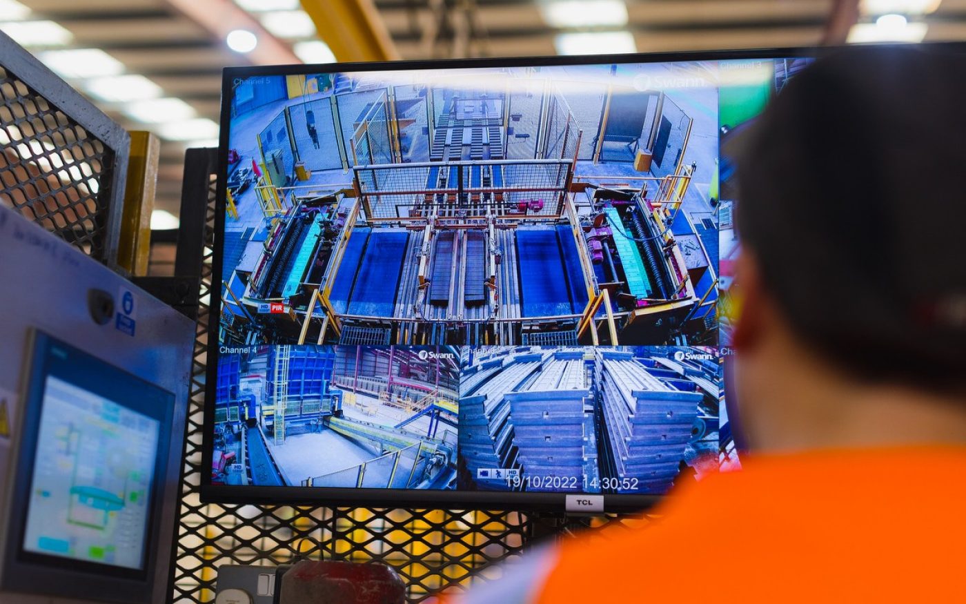 Two men in high vis gear at the edge of a lake