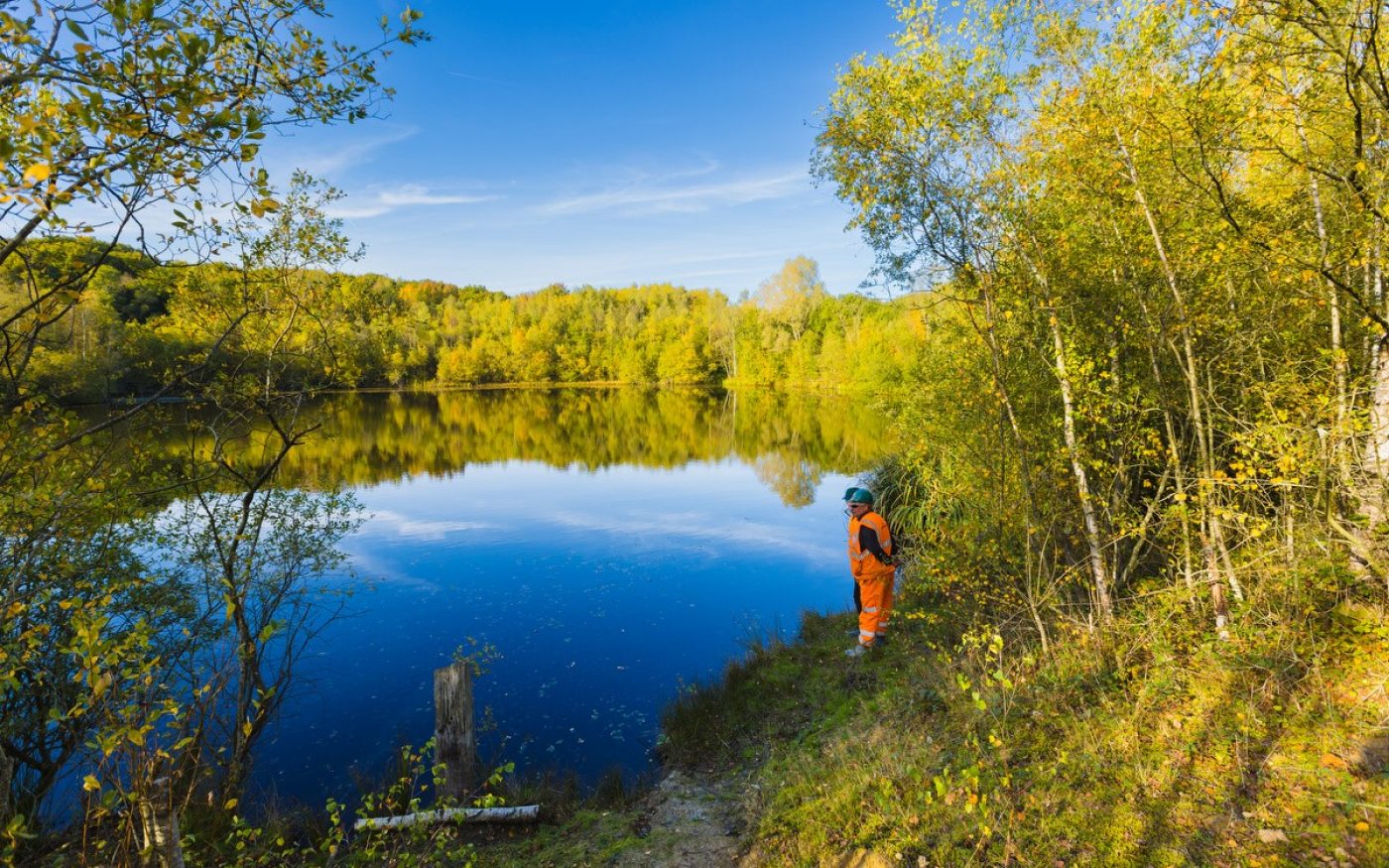 Man inspecting lake at Ewhurst nature site