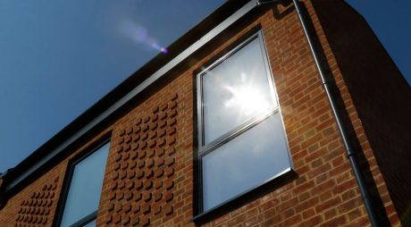 Sunlight shining on windows in a brick building
