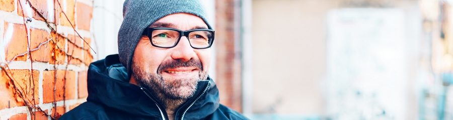 Thoughtful man smiling as he stares ahead