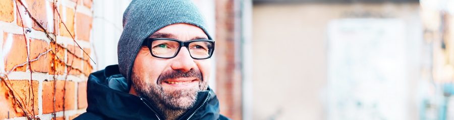 Thoughtful man smiling as he stares ahead
