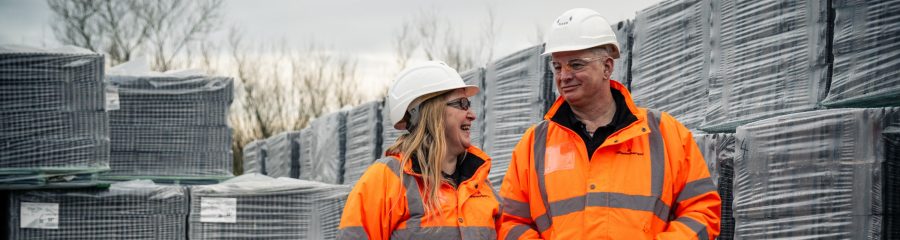 two employees walking through stock yard
