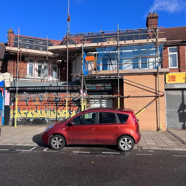 scaffolding around a terranced house on a highstreet