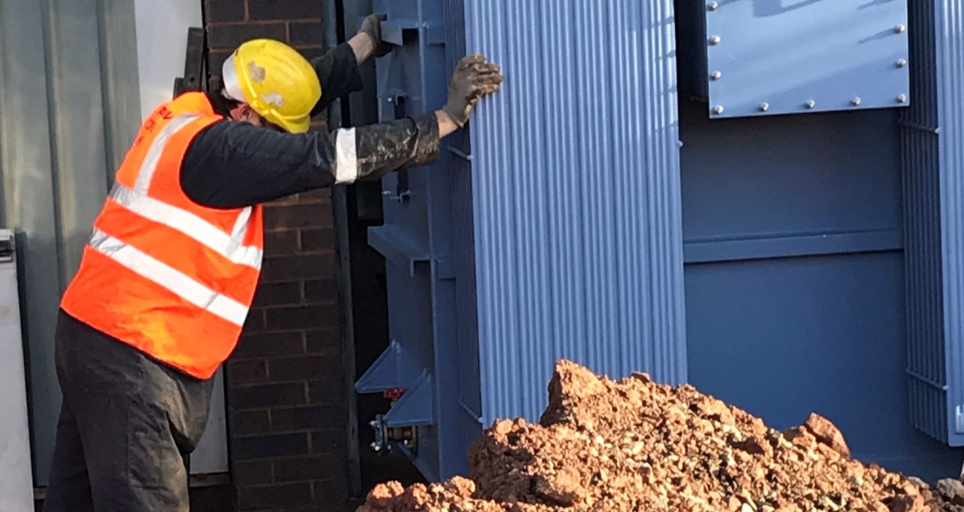 Man in safety gear installing energy transformer