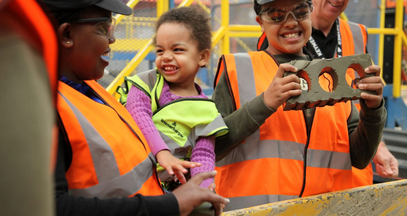 Children at factory learning about brick production