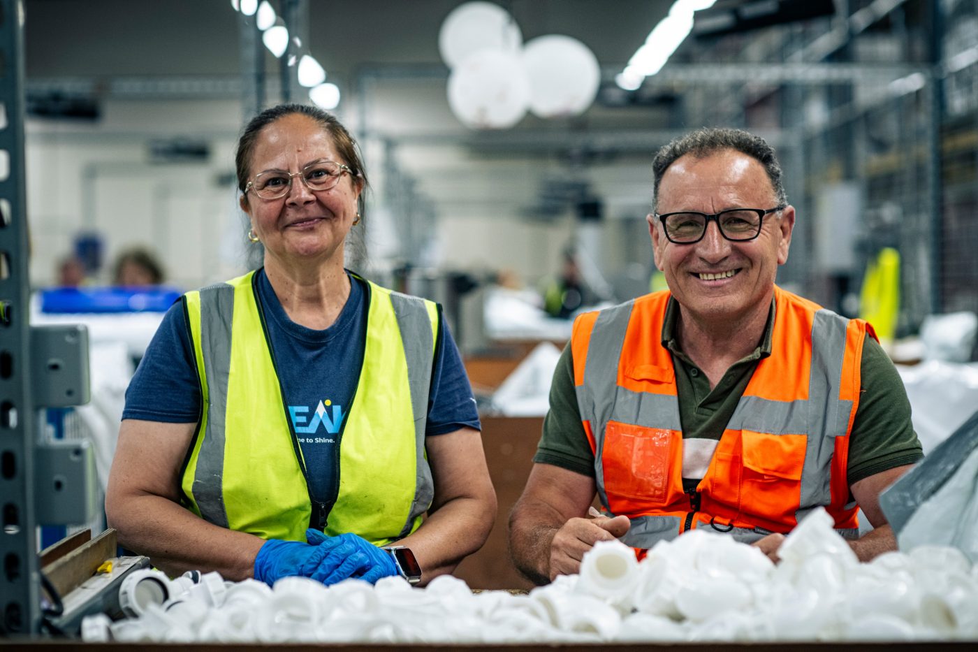 two floplast employees sat in production smiling at the camera