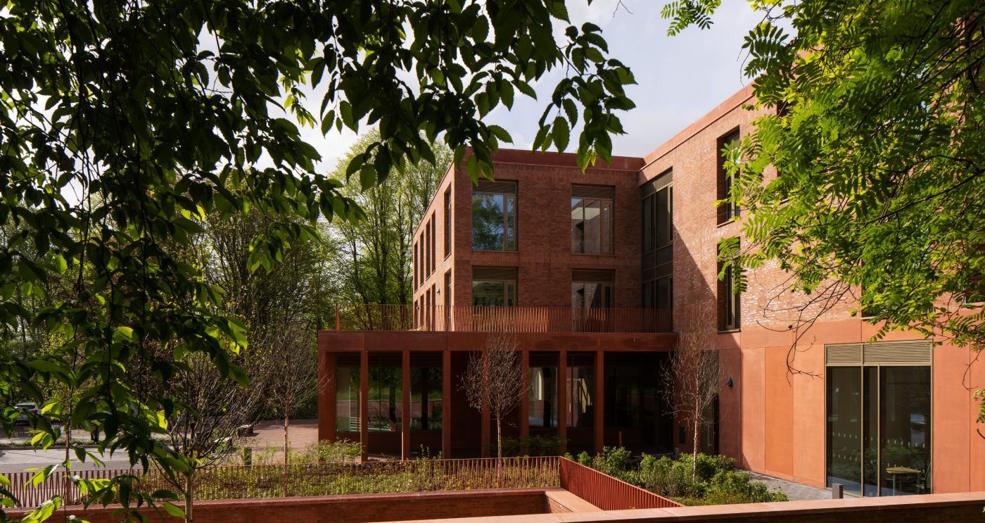 Trees and bushes surrounding the multi-storey Riddel Hall