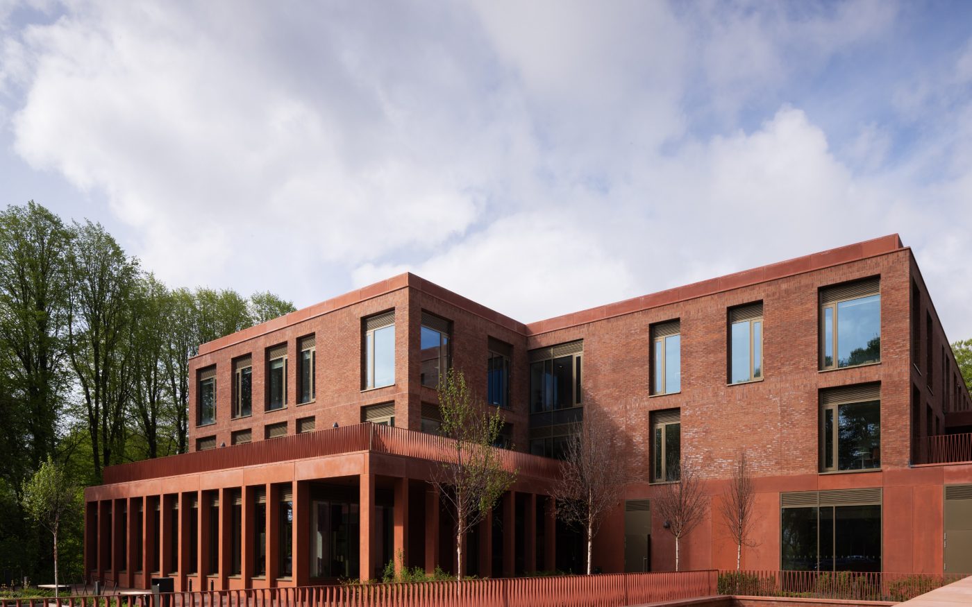 Beautiful red brick building surrounded by greenery and trees
