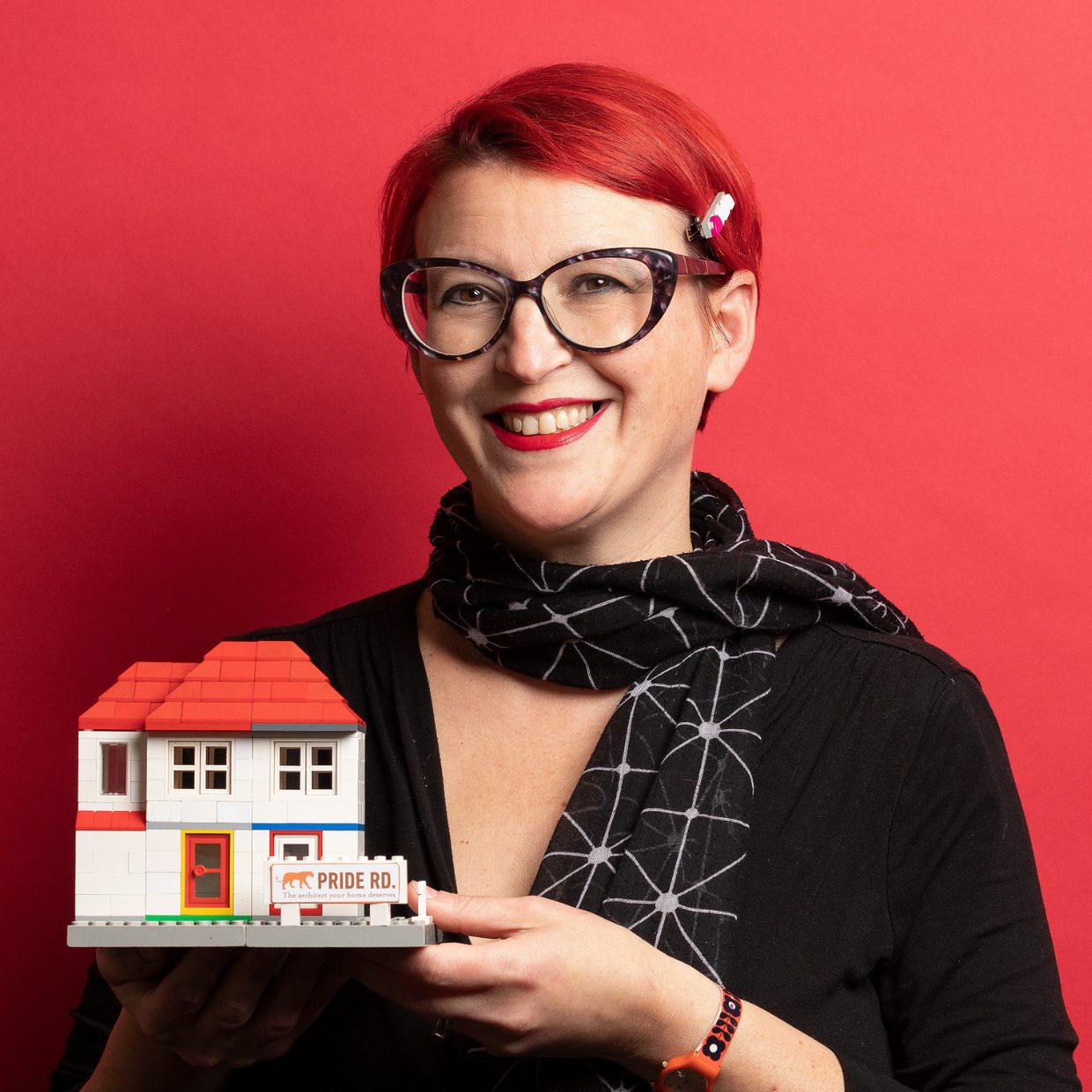 Lisa Raynes posing with lego house