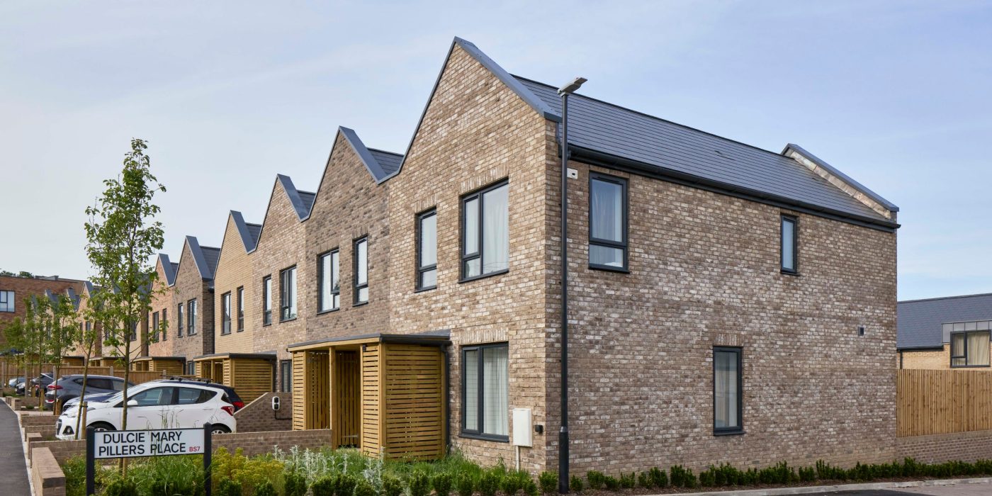 row of buff brick modern terraced houses