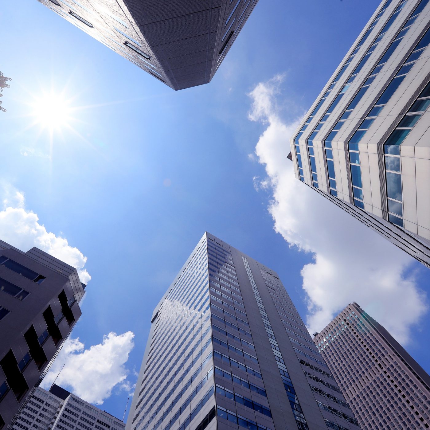 High rise buildings with blue skys and clouds behind