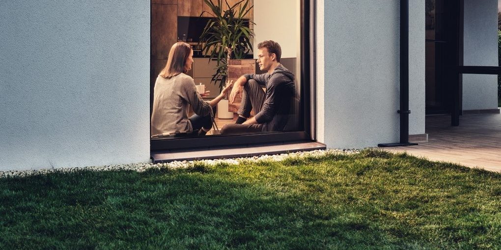 Two people sat in a window talking